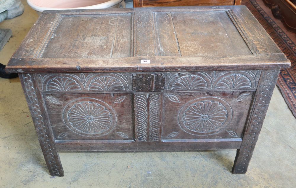 An 18th century carved panelled oak coffer, W.96cm, D.49cm, H.62cm